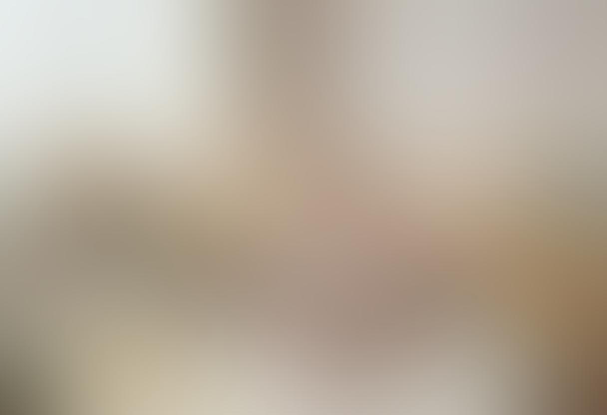 A cozy nursery scene featuring a joyful baby playing with colorful interactive toys, surrounded by adorable plush gifts. Soft pastel colors dominate the room, creating a warm, inviting atmosphere. An open gift box reveals more cute toys, while framed baby milestones adorn the walls. Incorporate gentle sunlight streaming through a window, highlighting the playful setting. super-realistic. vibrant colors. soft lighting.